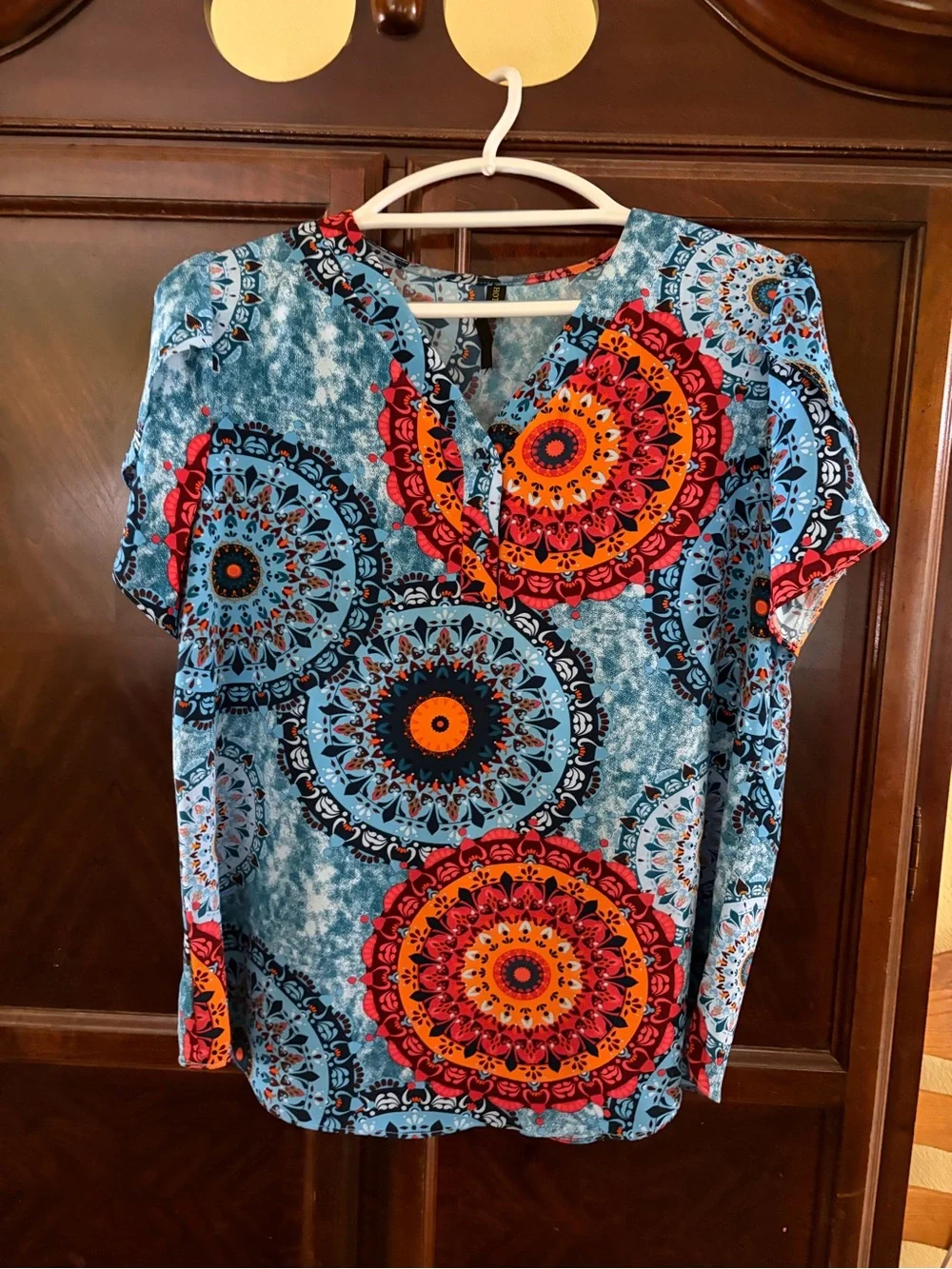 V-Neck Blue Medallion Short Sleeve Top with Orange Accents